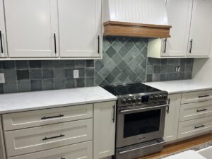 finished white RTA kitchen cabinets with quartz countertops and tile backsplash