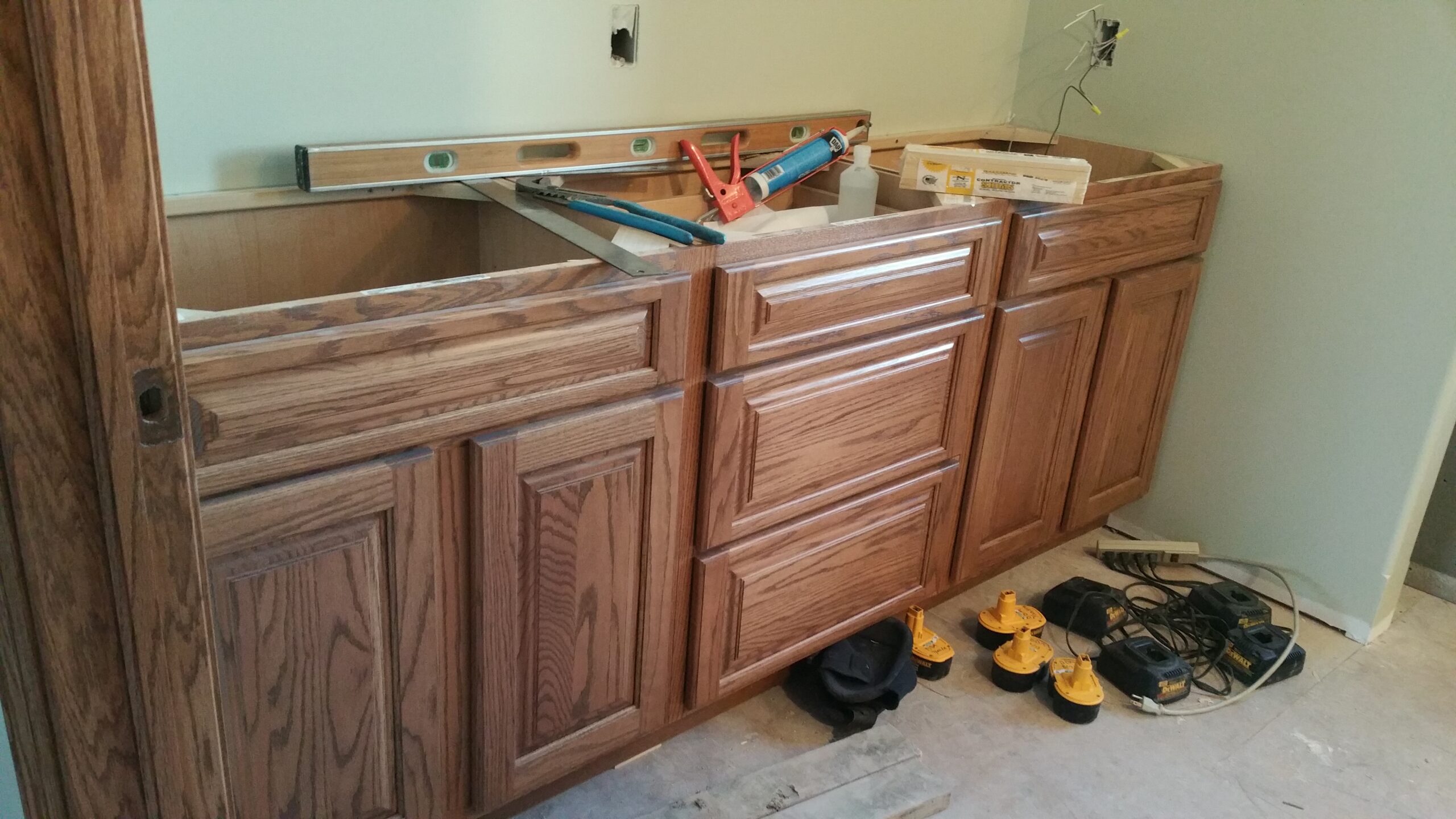 Installer leveling a cabinet during a kitchen renovation